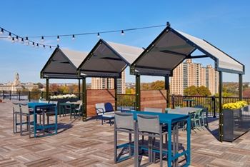 A patio with tables and chairs under umbrellas.